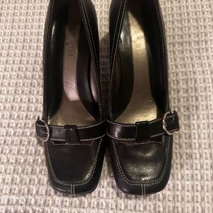 Nine West pumps black leather with white stitching.